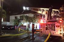 Firefighters battle a two-alarm blaze in a vacant building at 307 S. Main St. early Monday, Dec ...