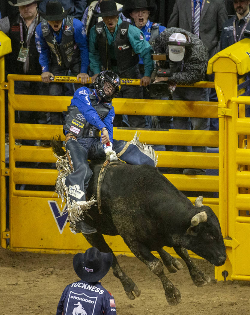 Stetson Wright of Milford, Utah, holds on tight atop Holy Holly for a score of 91.0 points and ...