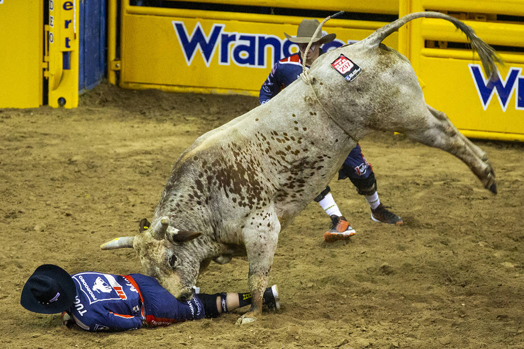 A bullfighter is driven into the dirt by Red Harvest in Bull Riding during the fourth go round ...