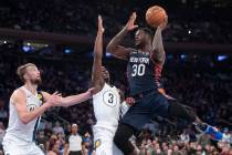 New York Knicks forward Julius Randle (30) goes to the basket against Indiana Pacers guard Aaro ...