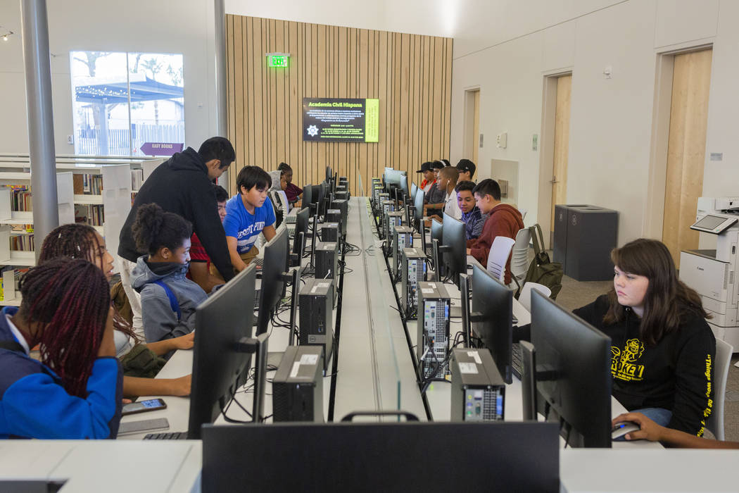 Youth do different actives in the computer lab at the East Las Vegas Library in Las Vegas on Tu ...