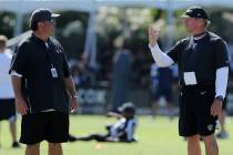 Oakland Raiders defensive coordinator Paul Guenther, left, meets with head coach Jon Gruden dur ...