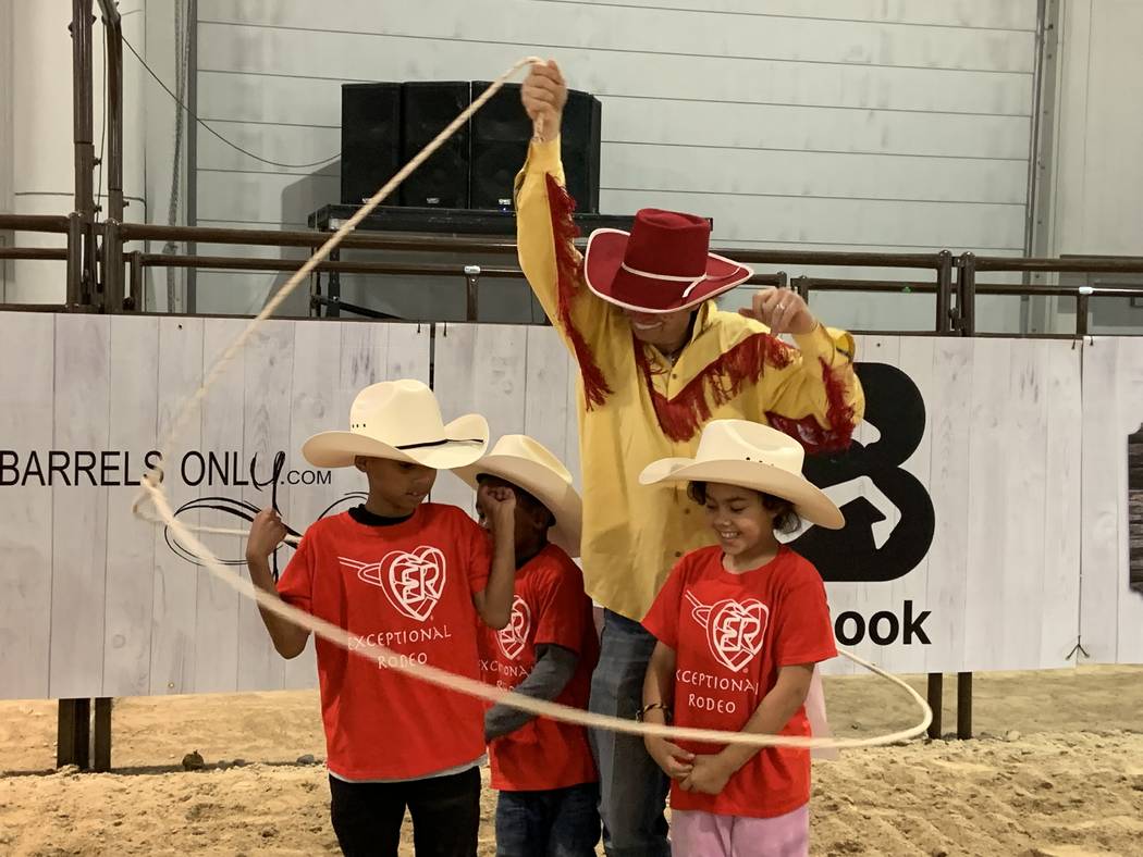 Wrangler NFR rodeo clown John Harrison displays his trick-roping skills to a group of local spe ...