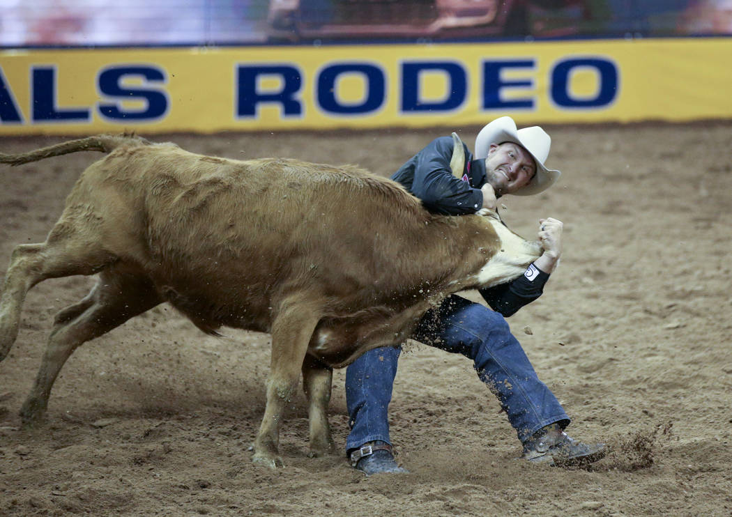 Kyle Irwin of Robertsdale, Ala. competes in Steer Wrestling during Bareback Riding in the fifth ...