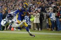 Los Angeles Rams running back Todd Gurley, right, stiff arms Seattle Seahawks cornerback Tre Fl ...