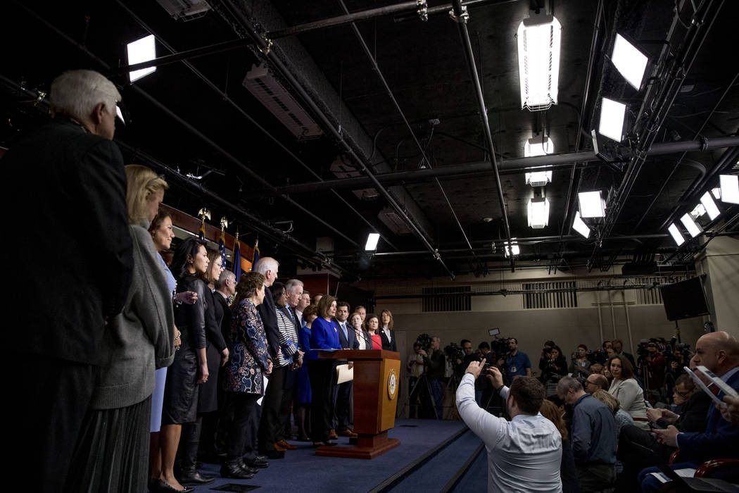 House Speaker Nancy Pelosi of Calif., accompanied by House Congress members, speaks at a news c ...