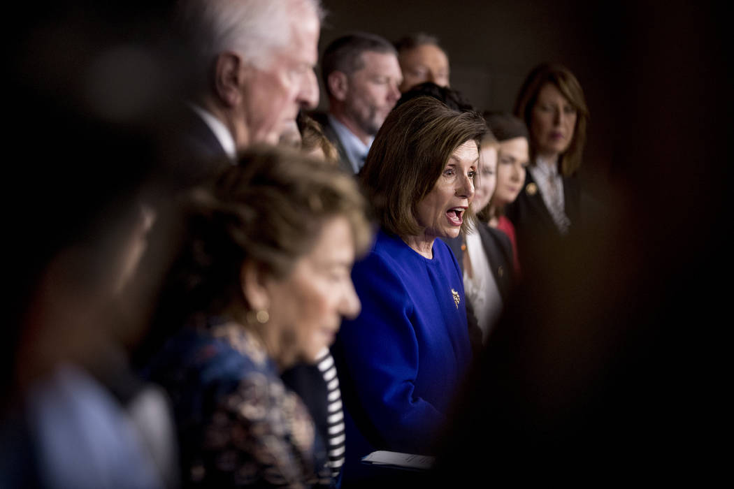 House Speaker Nancy Pelosi of Calif., accompanied by House Congress members, speaks at a news c ...