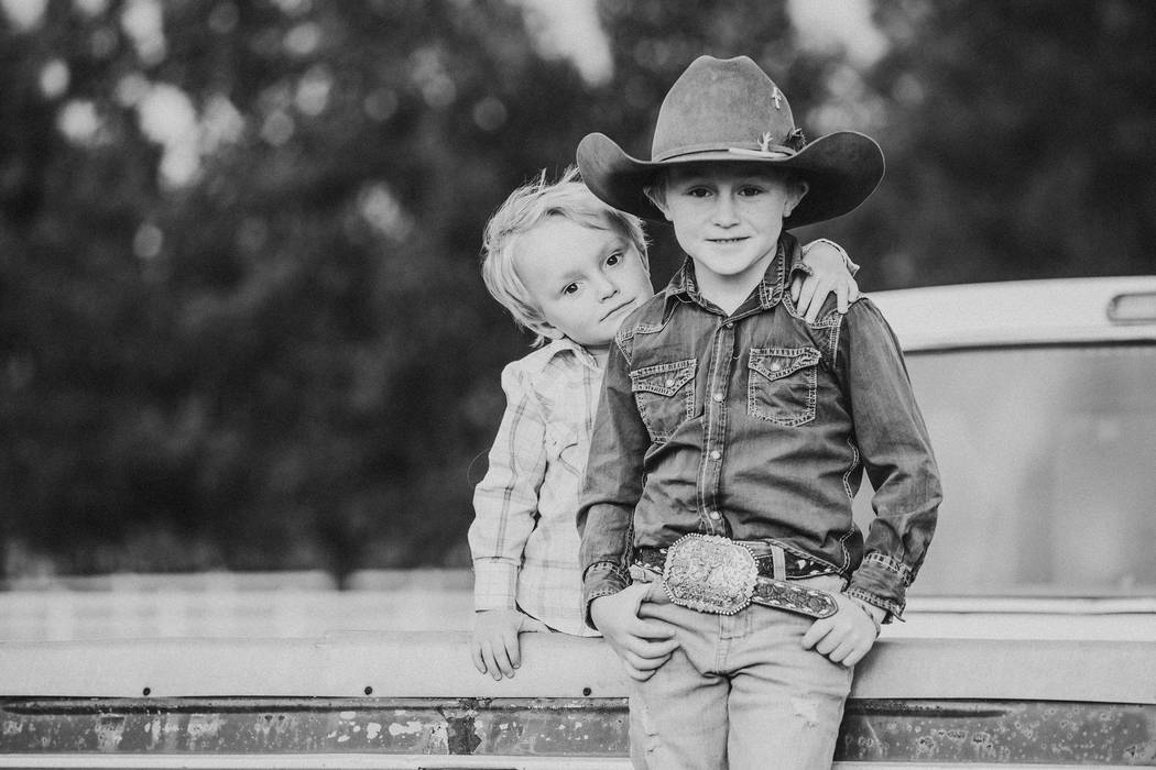 Max Henderson, right, with his brother Murphy, 4. Max, 7, died practicing roping in September, ...