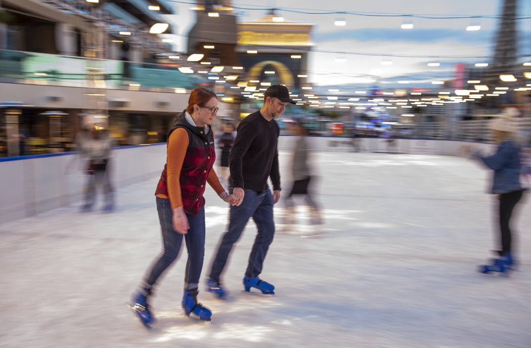 Lauren, left, and Kyle Kaehler of Sacramento skate on the ice rink at The Cosmopolitan of Las V ...