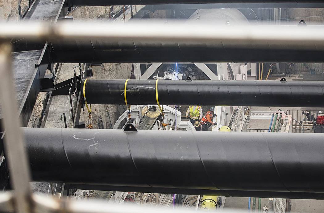 The tunnel boring machine begins work at the future location of one of the underground people m ...