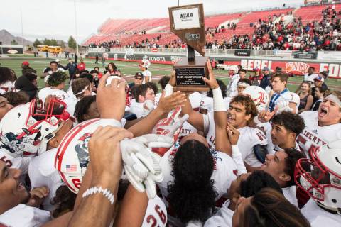 Liberty players celebrate after defeating Centennial 50-7 to win the Class 4A state football ch ...