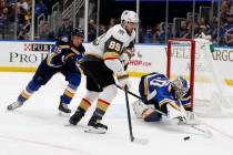 Vegas Golden Knights' Alex Tuch (89) reaches for the puck as St. Louis Blues goaltender Jordan ...