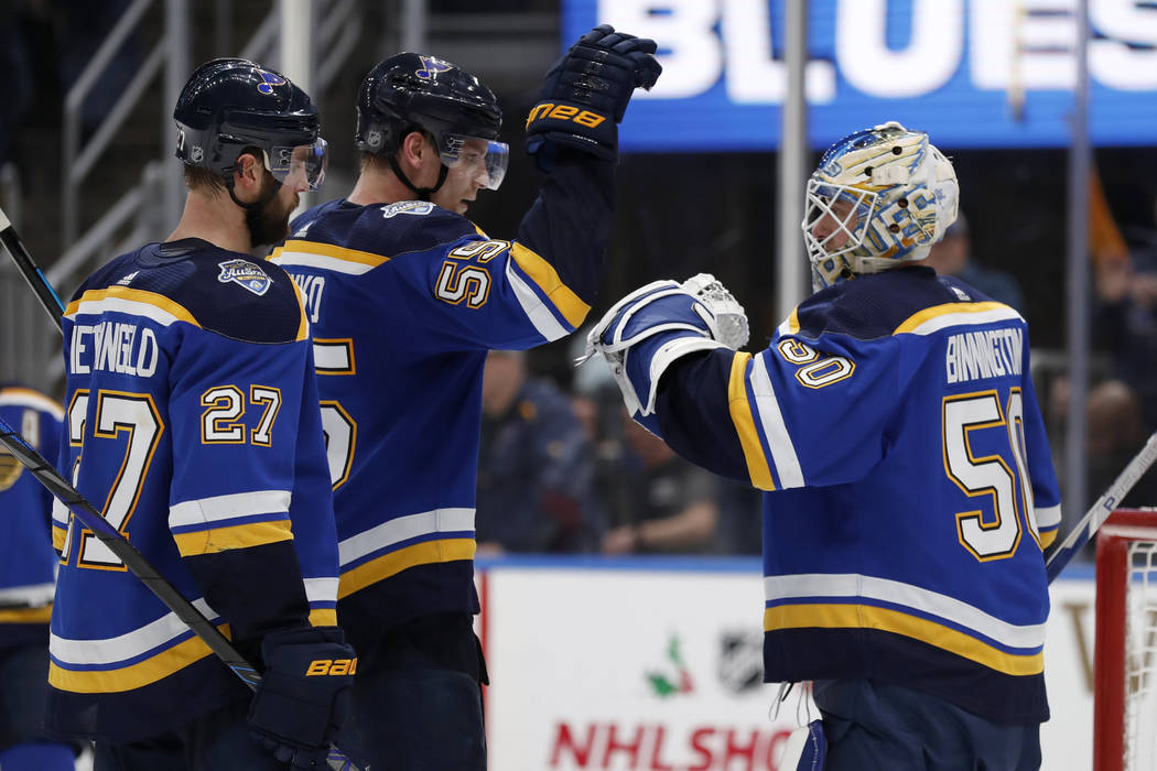 St. Louis Blues goaltender Jordan Binnington, right, celebrates with teammates Colton Parayko a ...