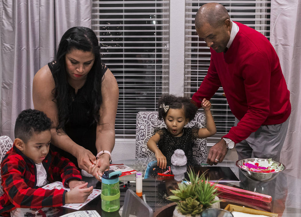 Dr. Sheldon Jacobs, right, daughter Arianna, 3, wife Nicole and son Jayden, 6, make holiday dec ...