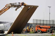 FILE - In this Feb. 27, 2019, file photo, a border wall prototype falls during demolition at th ...