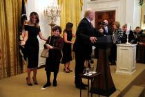 First lady Melania Trump, left, and Karen Pence, wife of Vice President Mike Pence, center, wel ...