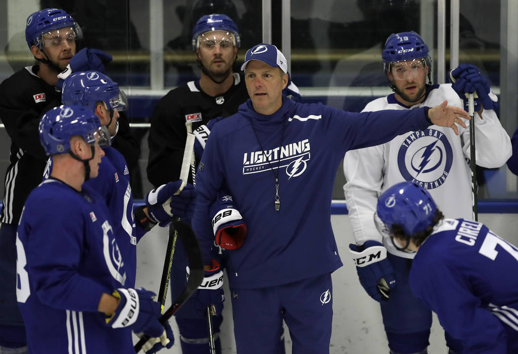 Tampa Bay Lightning head coach Jon Cooper, center, goes over a drill during the first day of NH ...