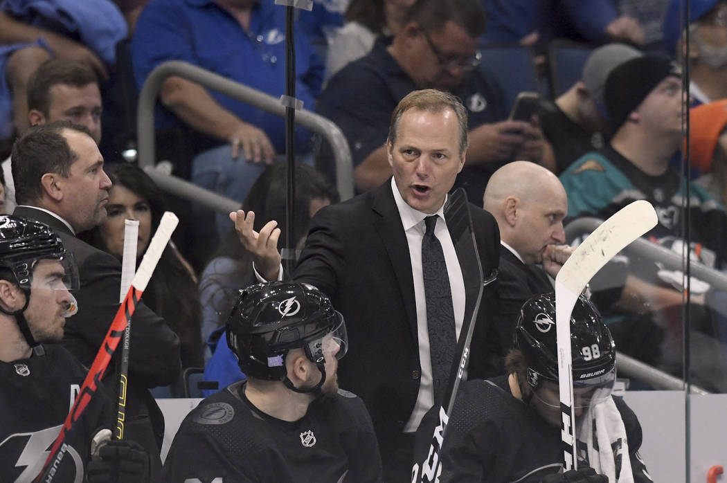 Tampa Bay Lightning head coach Jon Cooper talks with his team during the first period of an NHL ...