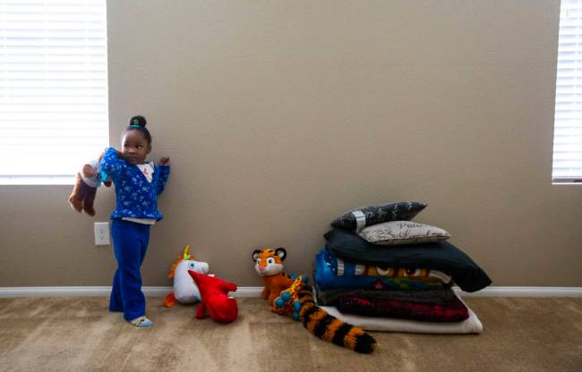 Christine Modica, 3, holds up a stuffed animal in the bedroom she shares with her great-aunt, L ...