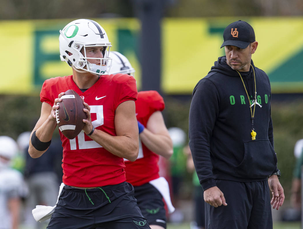 Oregon quarterback Tyler Shough works out under the watchful eye of coach Marcus Arroyo during ...