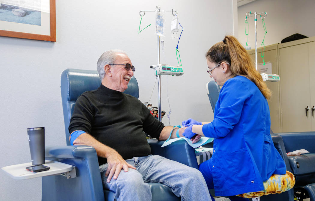 Fred Warnick, 73, the first patient in the world on a new lymphoma clinical trial, left, receiv ...