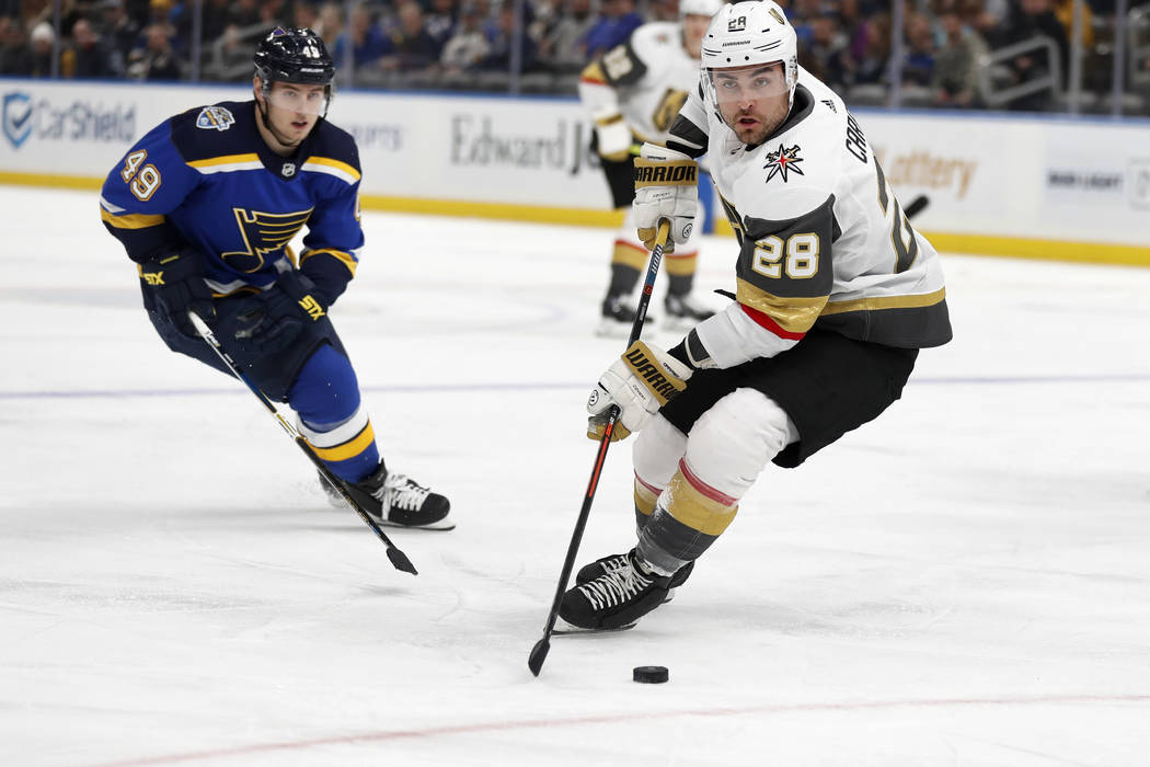 Vegas Golden Knights' William Carrier (28) handles the puck as St. Louis Blues' Ivan Barbashev ...