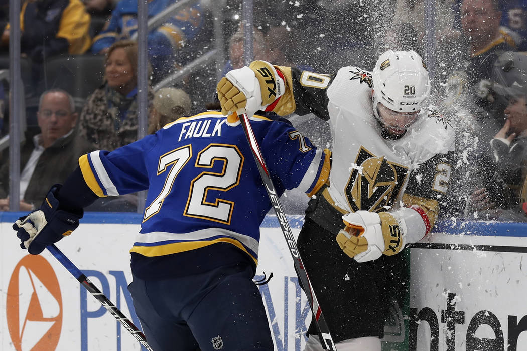 St. Louis Blues' Justin Faulk (72) checks Vegas Golden Knights' Chandler Stephenson into the bo ...