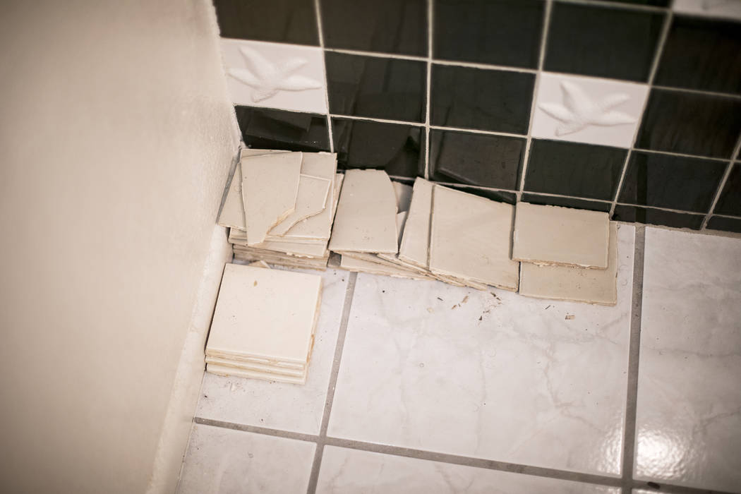 John and Mary Bodimer have gathered tiles that have fallen from the leaking ceiling in the gues ...