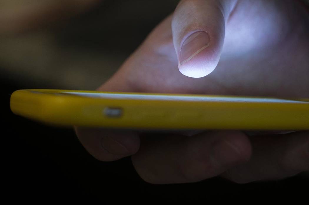 An Aug. 11, 2019, file photo, shows a man using a cell phone in New Orleans. The Federal Commun ...