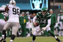 New York Jets quarterback Sam Darnold (14) scrambles with the football as Oakland Raiders defen ...