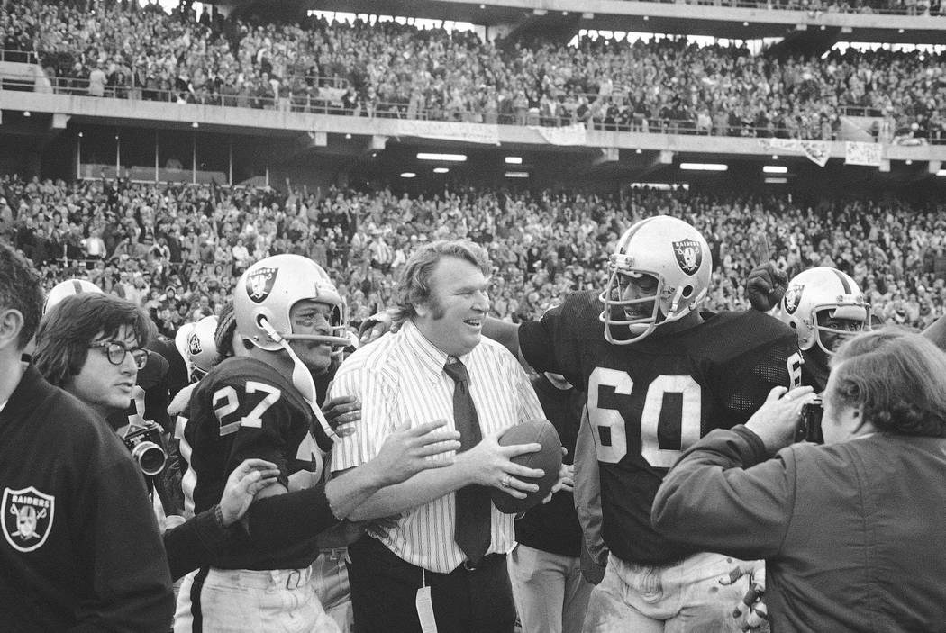 FILE - In this Dec. 21, 1974, file photo, Oakland Raiders coach John Madden holds the ball whic ...