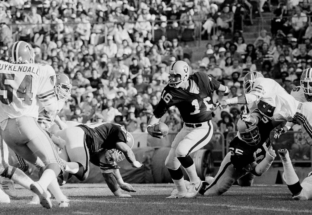 Oakland Raiders quarterback Jim Plunkett (16) gets his shirt pulled by Atlanta Falcons Joel Wil ...