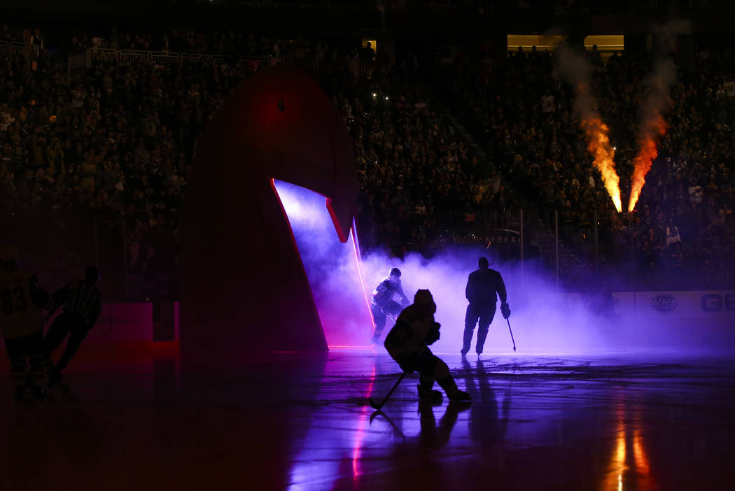 Golden Knights players skate onto the ice before the start of an NHL hockey game against the Ar ...