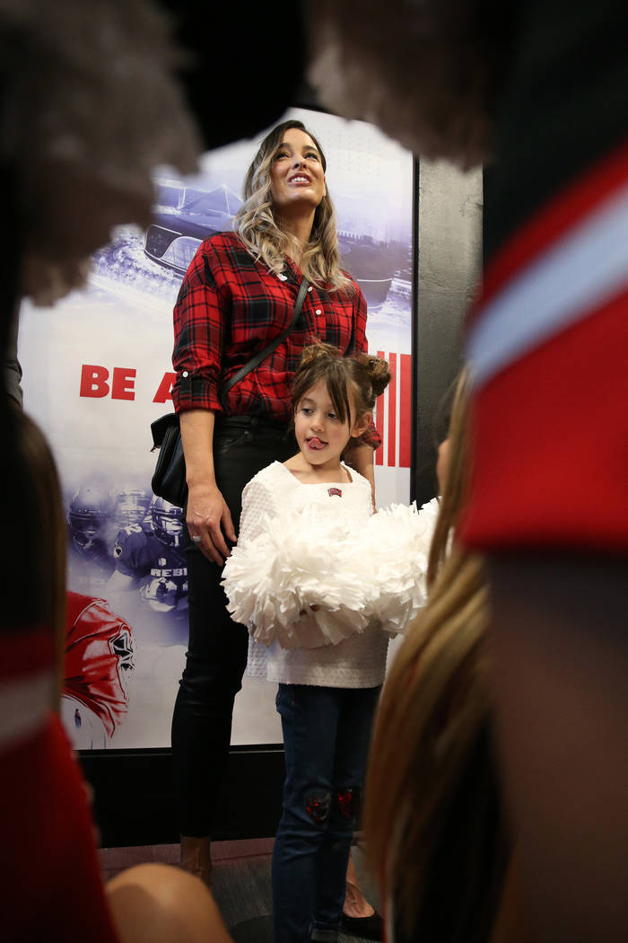 Kelly Arroyo and daughter Cruz, 6, the family of UNLV's new football coach Marcus Arroyo, atten ...