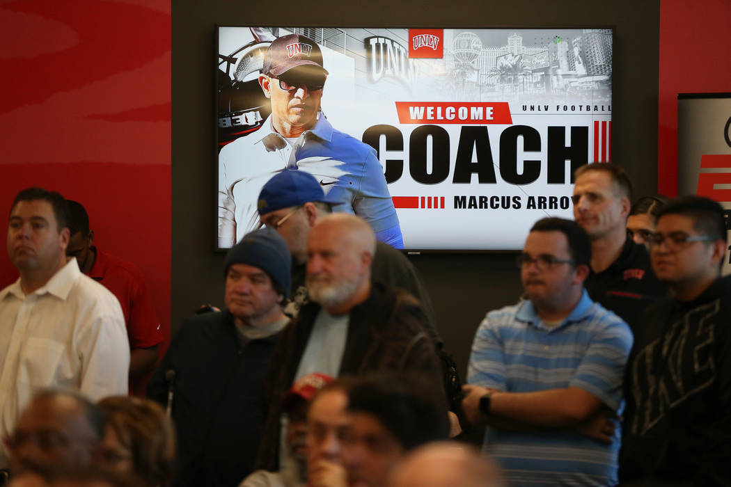 People attend a press conference to announce UNLV's new football head coach Marcus Arroyo, at U ...