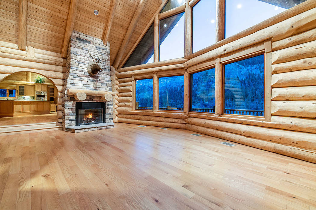 Berkshire Hathaway Home Services The living room has plenty of windows and a rustic wood-burnin ...