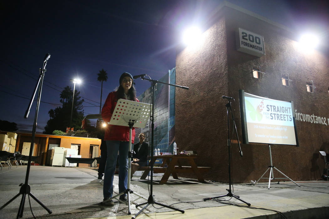 Merideth Spriggs, chief kindness officer for Caridad, speaks during a candlelight vigil to memo ...