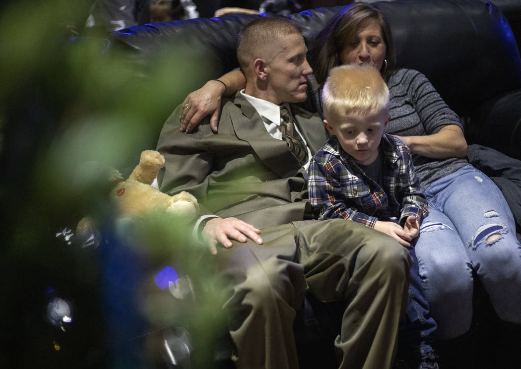 Raedyn Brackeen, 3, sits between his parents Robert Brackeen, left, and Carsen Brackeen, right, ...