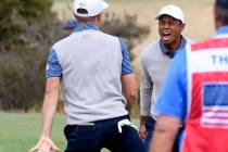 U.S. team player Justin Thomas, left, celebrates with his playing partner and captain, Tiger Wo ...