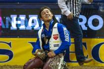 Clayton Biglow of Clements, Calif., looks up and smiles after he rides Ankle Biter to a first p ...