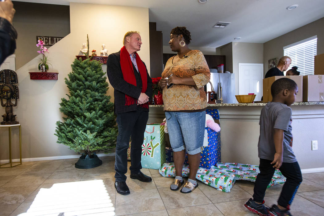 Lucille McKnight, right, talks with Walker Furniture CEO Larry Alterwitz in her home in Las Veg ...