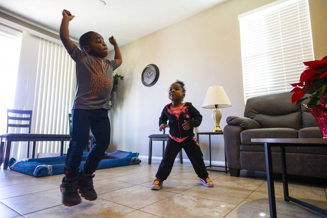 Noel Modica, 4, dances around the living room with his sister, Christine Modica, 3, after Walke ...