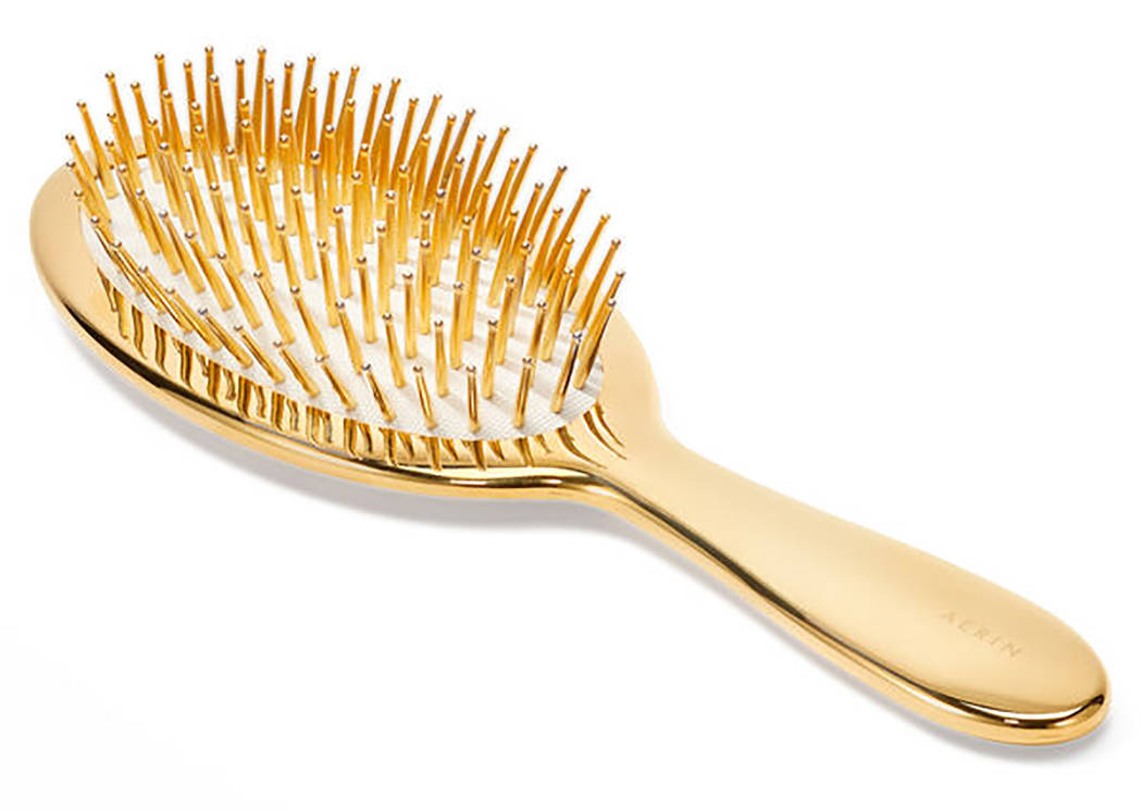 Handcrafted in Italy, AERIN's classic hairbrush features gold-tipped ivory bristles. aerin.com