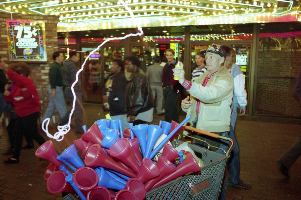 A vendor on Fremont Street sells party horns on New Year's Eve 1993. (Las Vegas Review-Journal ...