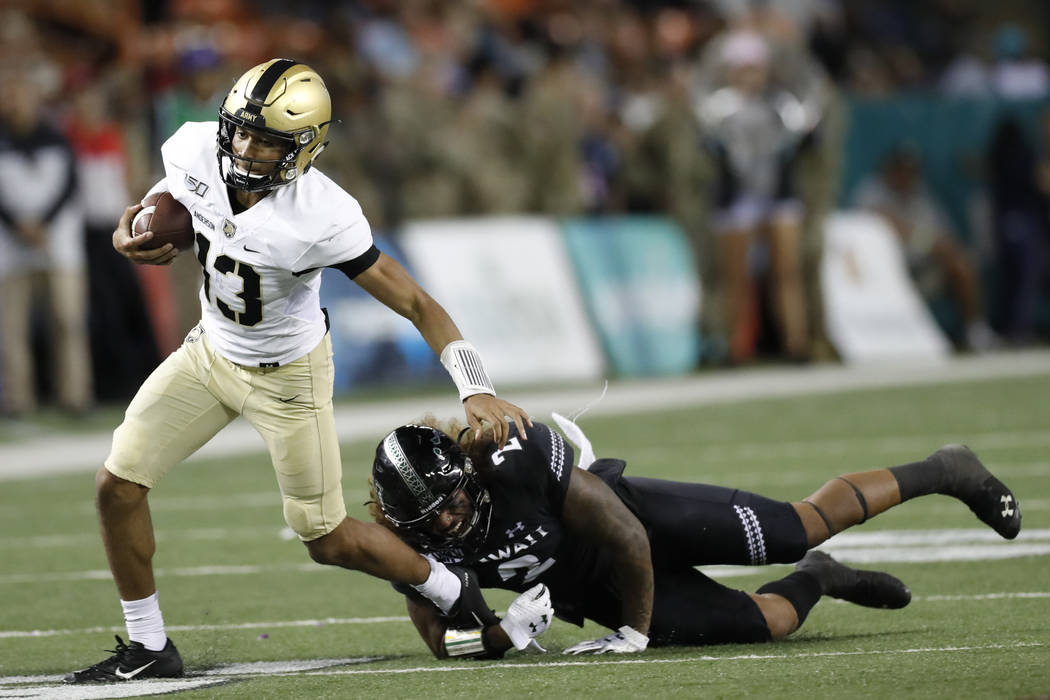 Hawaii linebacker Jeremiah Pritchard (2) tackles Army quarterback Christian Anderson (13) durin ...