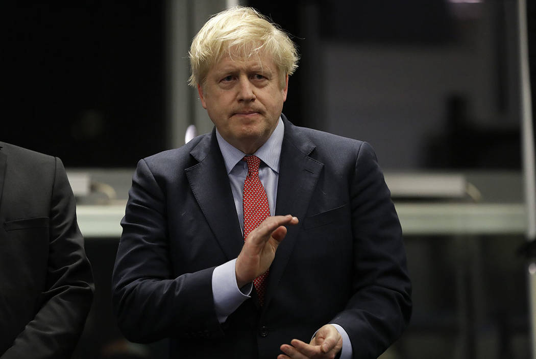 Britain's Prime Minister and Conservative Party leader Boris Johnson applauds during the Uxbrid ...