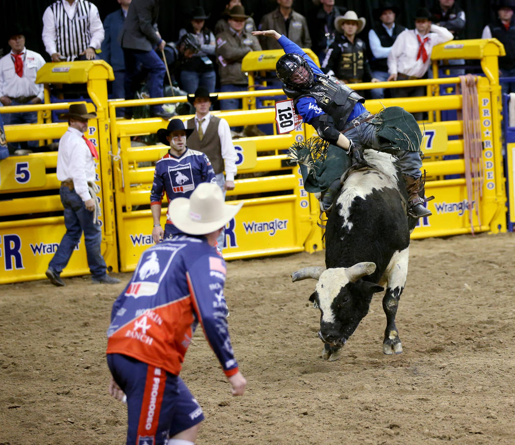 Trey Benton III of Rock Island, Texas rides Twenty to Life in the Bull Riding competition durin ...