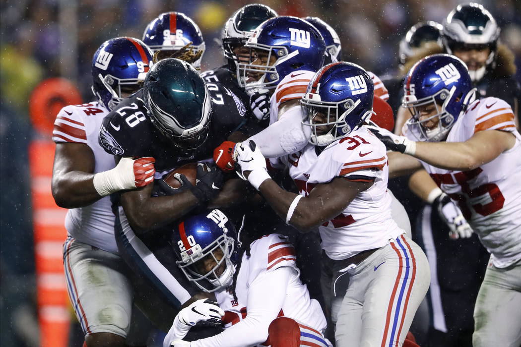 Philadelphia Eagles' Jay Ajayi (28) is tackled by New York Giants' Dalvin Tomlinson (94), Janor ...