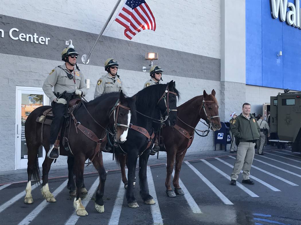 The Metropolitan Police Department's mounted police watch the festivities during a "Santa Cops" ...