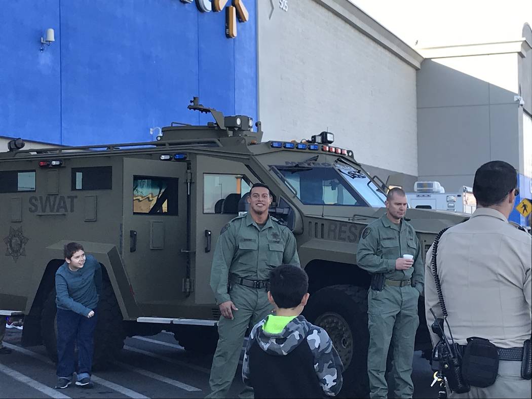 The Metropolitan Police Department's SWAT unit watch the festivities during a "Santa Cops" even ...